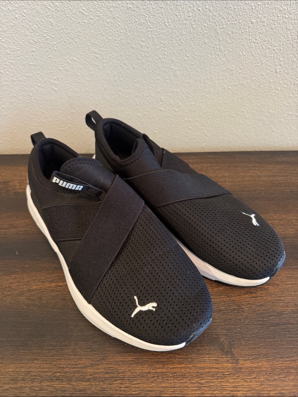 Puma women’s Black Slip-On Athletic Sneakers with White Sole